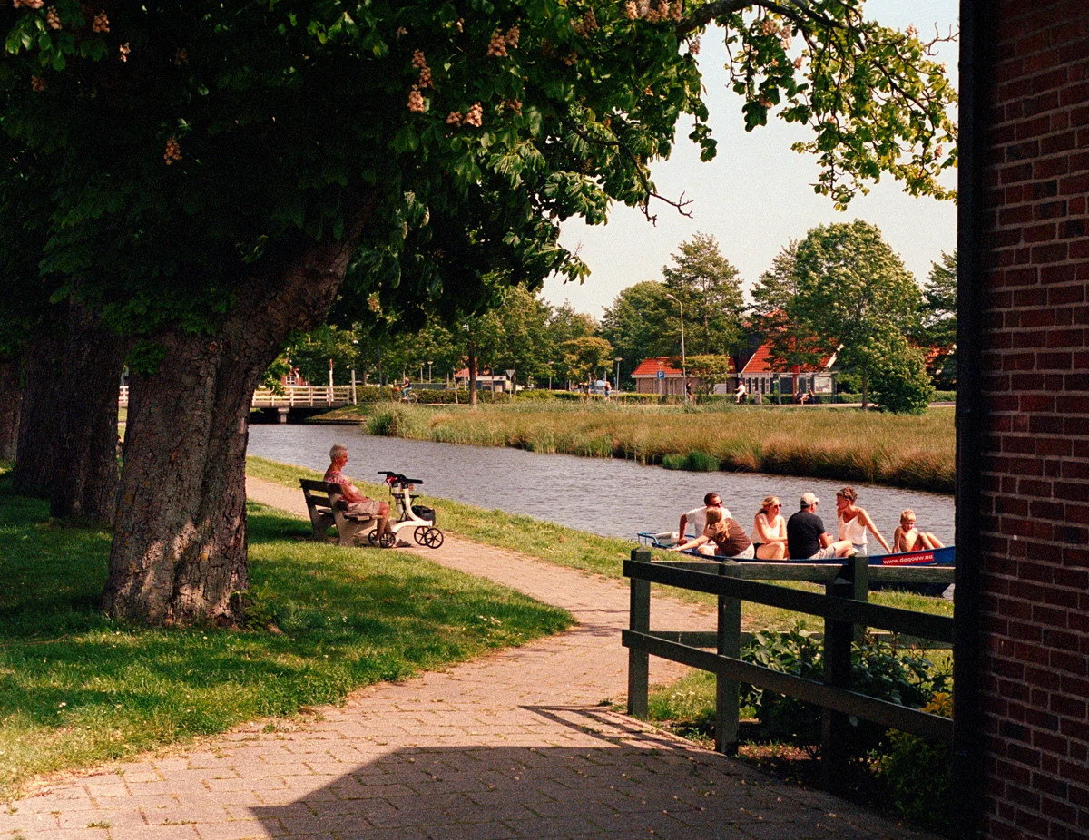 Woman watching people on a boat in de Rijp